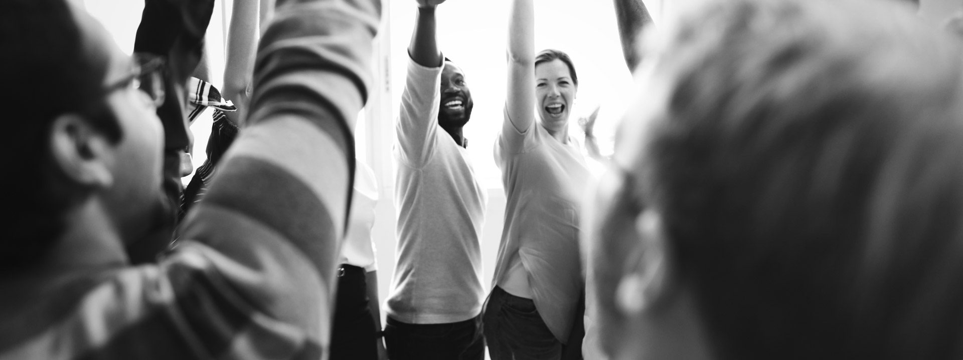 diversity-teamwork-with-raised-hands-narrow